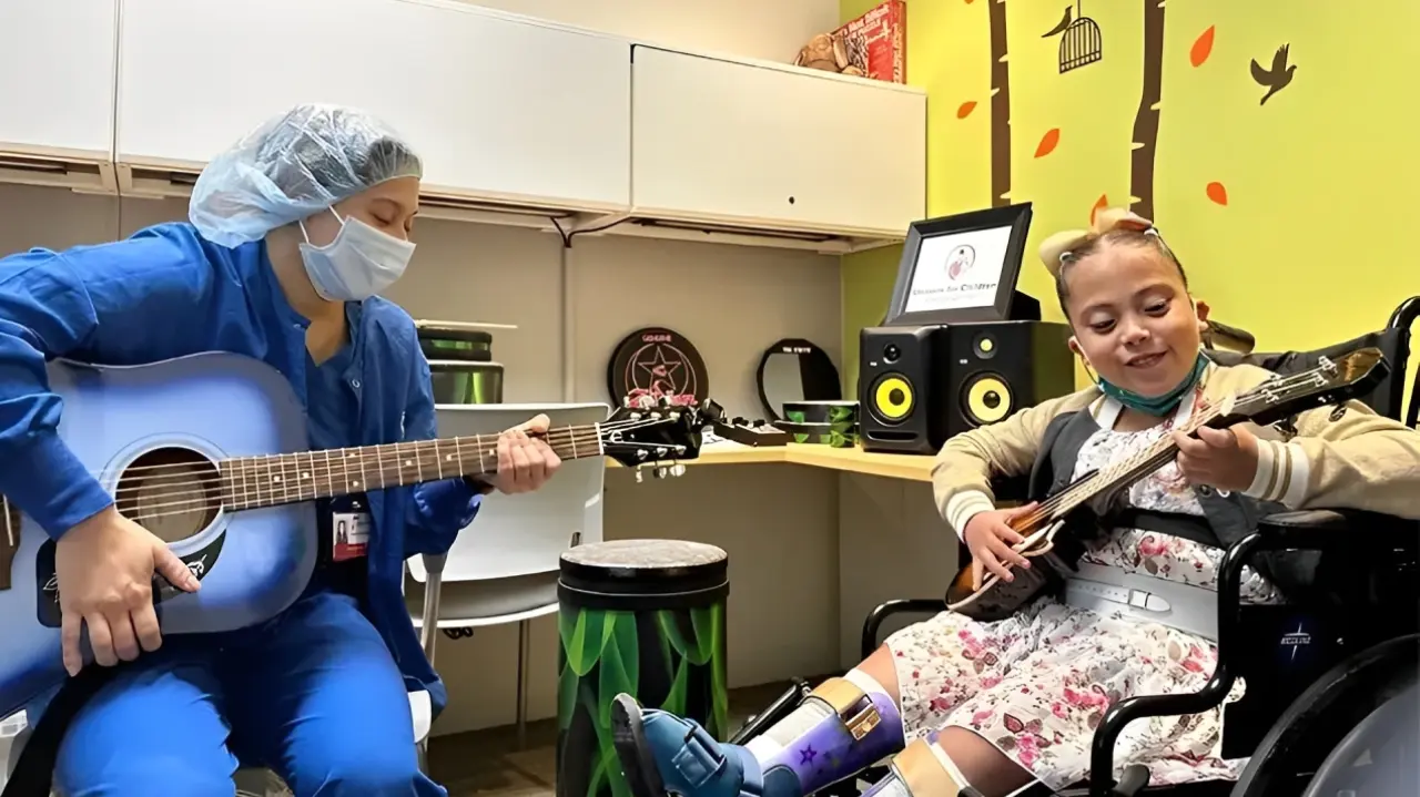 Two children playing musical instruments in a cozy room.