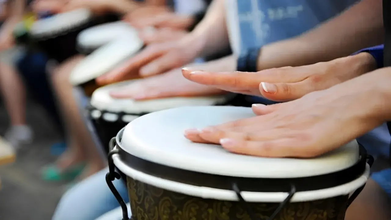 Close-up of hands playing drums.
