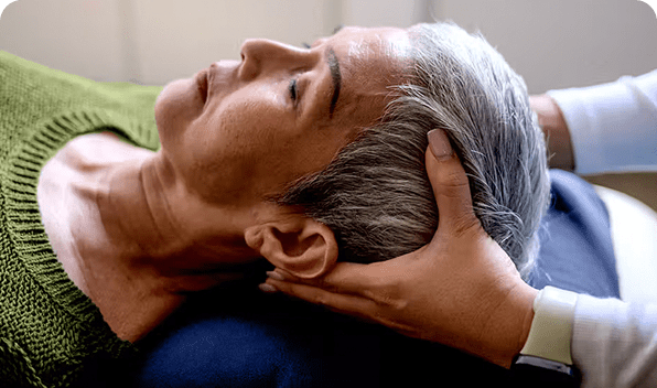A person receiving a gentle head massage.