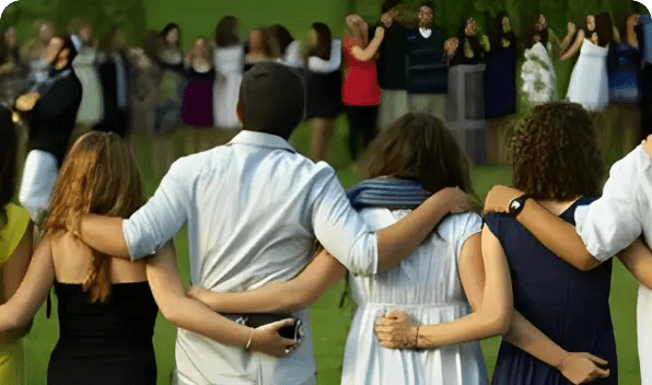 A group of people standing in a circle with arms around each other.