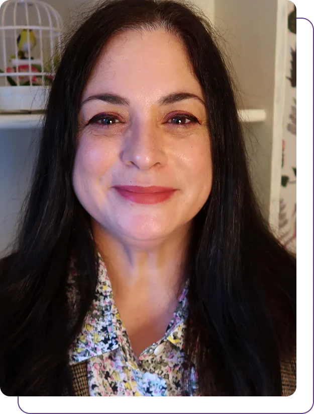 Group 1321317533 A smiling woman with long dark hair.